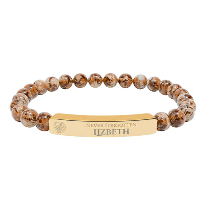 A natural stone bead engraved bracelet, personalized, with the text "Never Forgotten" with engraved elephant