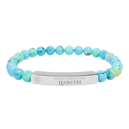 A natural stone bead engraved bracelet, personalized, with the text "Never Forgotten" with engraved elephant