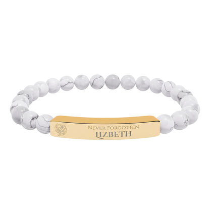 A natural stone bead engraved bracelet, personalized, with the text "Never Forgotten" with engraved elephant