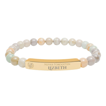 A natural stone bead engraved bracelet, personalized, with the text "Never Forgotten" with engraved elephant