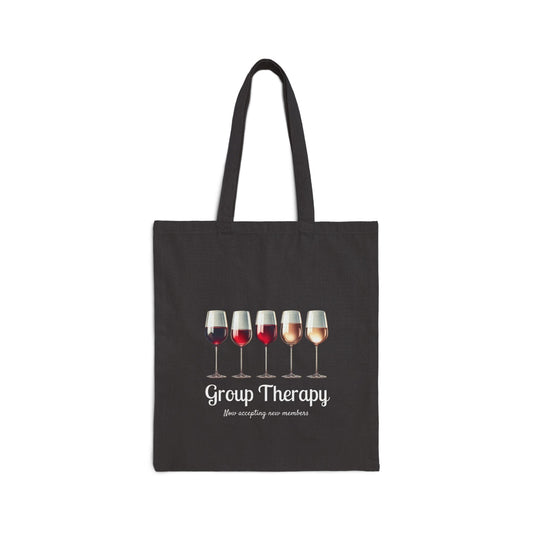 A dark tote bag featuring five wine glasses in assorted colors with the text "Group Therapy" and "now accepting new members"